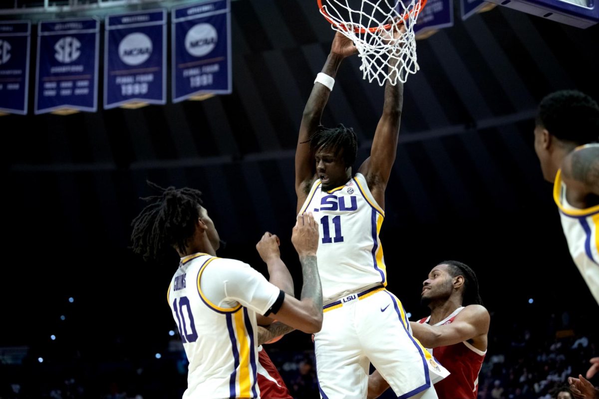 LSU men's basketball redshirt freshman forward Corey Chest (11) swings from the rim during LSU's 78-74 win against Arkansas on Tuesday, Jan. 14, 2025, in the Pete Maravich Assembly Center in Baton Rouge, La.