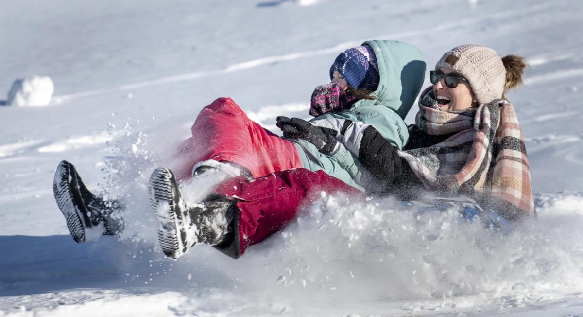 A mother and daughter plow through the snow in Auburn, Maine, Monday, Jan. 20, 2025. 