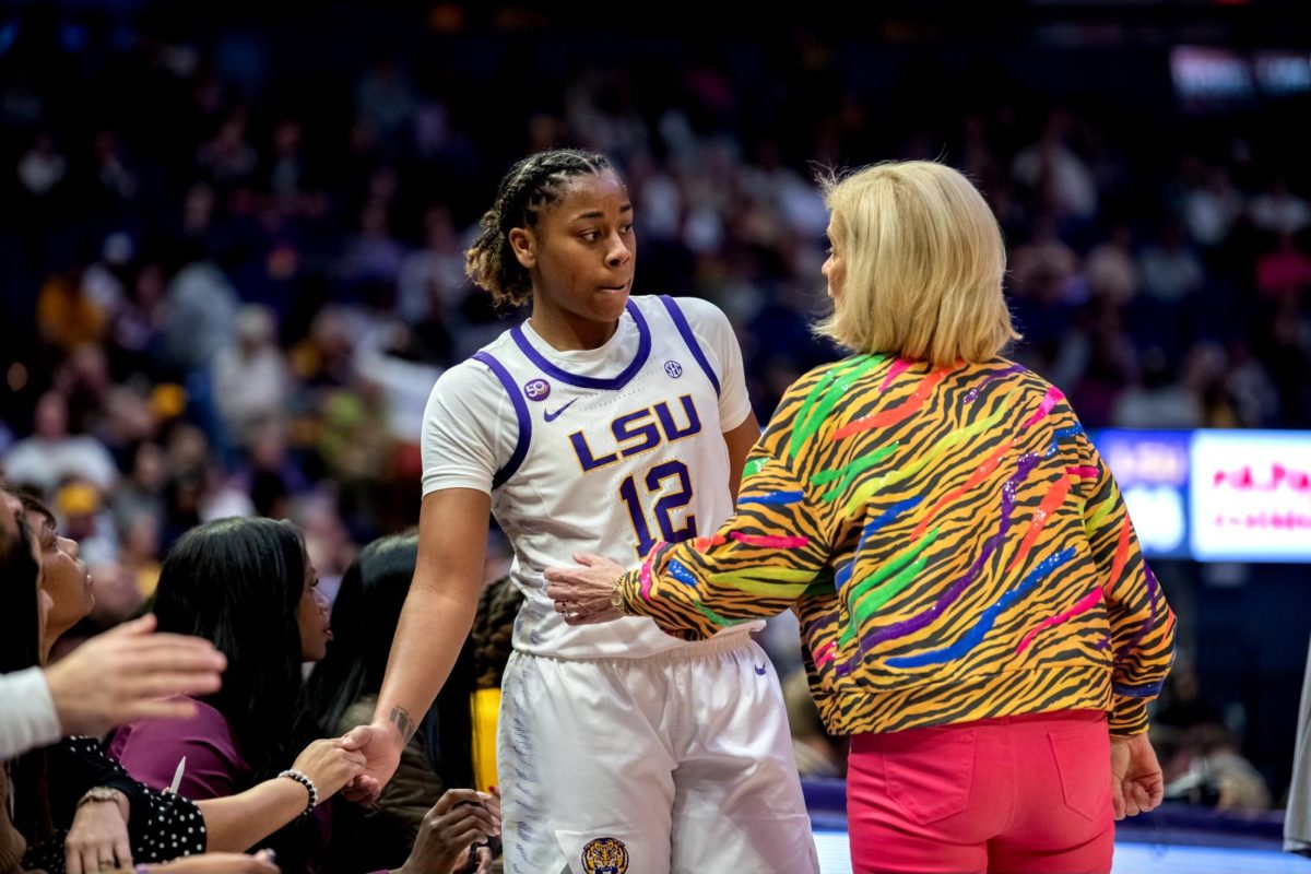 LSU women's basketball sophomore guard Mikaylah Williams (12) talks to head coach Kim Mulkey during LSU's 83-77 win against Vanderbilt on Monday, Jan. 13, 2025, in the Pete Maravich Assembly Center in Baton Rouge, La.