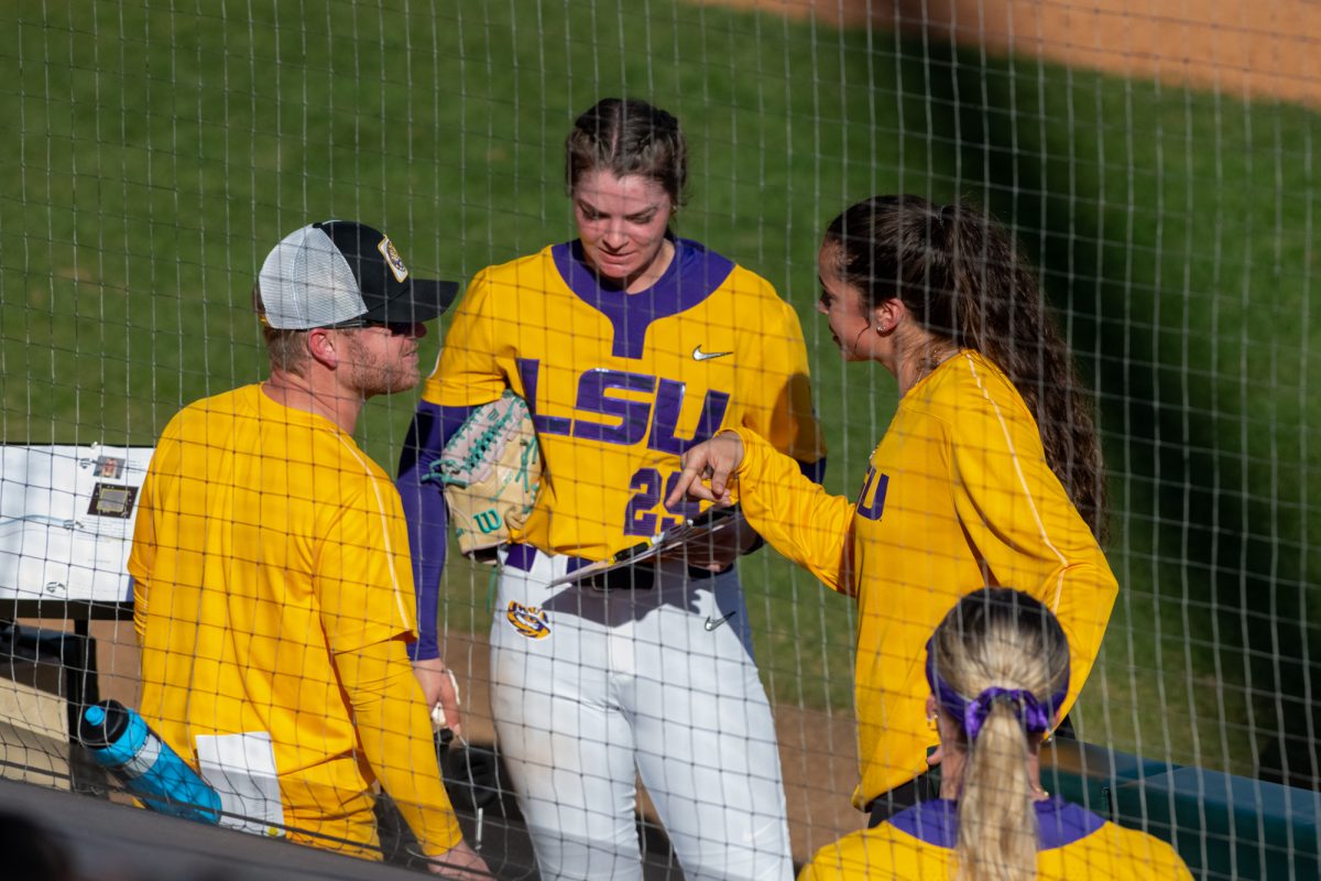 LSU softball junior pitcher Sydney Berzon (29) discusses with coaches during LSU's 3-2 win against Southeastern on Feb 9, 2025, in Baton Rouge, La.