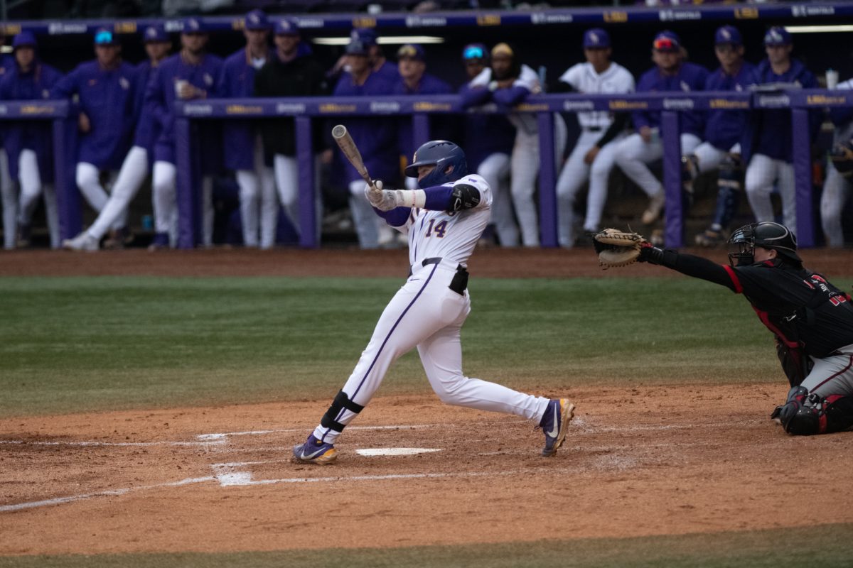 LSU baseball junior infielder Daniel Dickinson (14) hits the ball during LSU's 4-2 win against Omaha on Friday, Feb 21, 2025, at Alex Box Stadium in Baton Rouge, La.