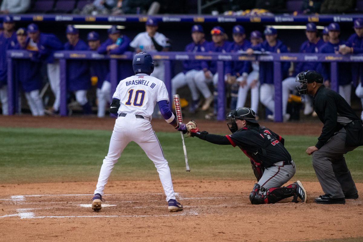 LSU baseball senior infielder Michael Braswell III fist-bumps with the Omaha catcher during LSU's 4-2 win against Omaha on Friday, Feb 21, 2025, at Alex Box Stadium in Baton Rouge, La.