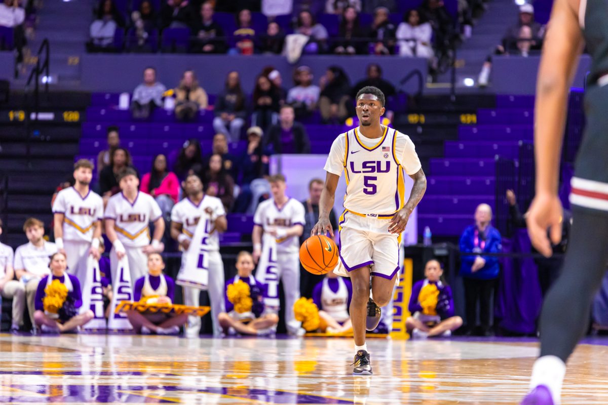 LSU men’s basketball senior guard Cam Carter (5) scans the court for an open teammate during LSU's 81-67 win against South Carolina on Tuesday, Feb. 18, 2025, in the Pete Maravich Assembly Center in Baton Rouge, La.