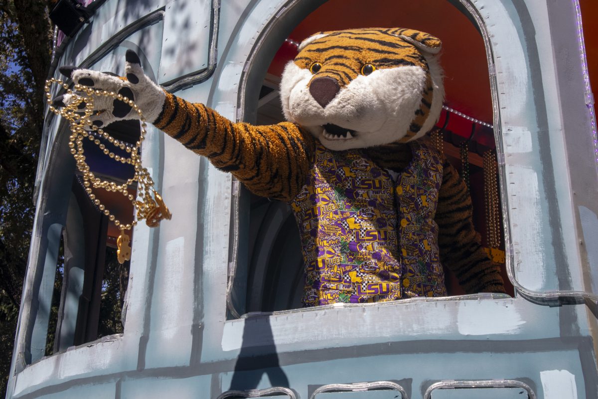 LSU mascot Mike the Tiger throws beads Tuesday, Feb. 25, 2025, on Tower Drive in Baton Rouge, La.