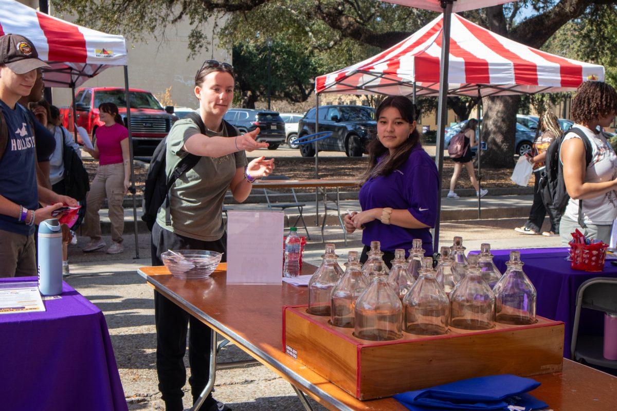 A student plays the ring toss game at the consent carnival Wednesday, Feb. 5, 2025, on Tower Drive in Baton Rouge, La.