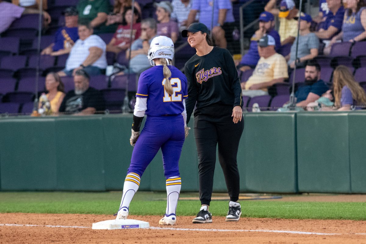 LSU softball junior catcher Maci Bergeron (12) talks to coach Beth Torina Saturday, Feb. 8, 2025, during LSU's 6-0 win against Central Arkansas at Tiger Park in Baton Rouge, La.