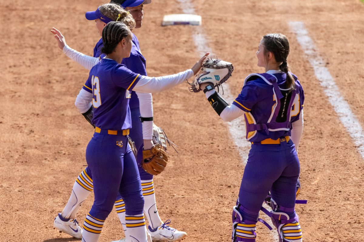 LSU softball redshirt senior third baseman Danieca Coffey (13) high fives freshman catcher Jada Phillips (28) Saturday, Feb. 8, 2025, during LSU's 10-0 win against Charlotte at Tiger Park in Baton Rouge, La.