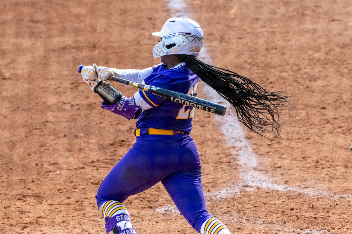 LSU softball junior infielder McKaela Walker (27) hits the ball Saturday, Feb. 8, 2025, during LSU's 10-0 win against Charlotte at Tiger Park in Baton Rouge, La.