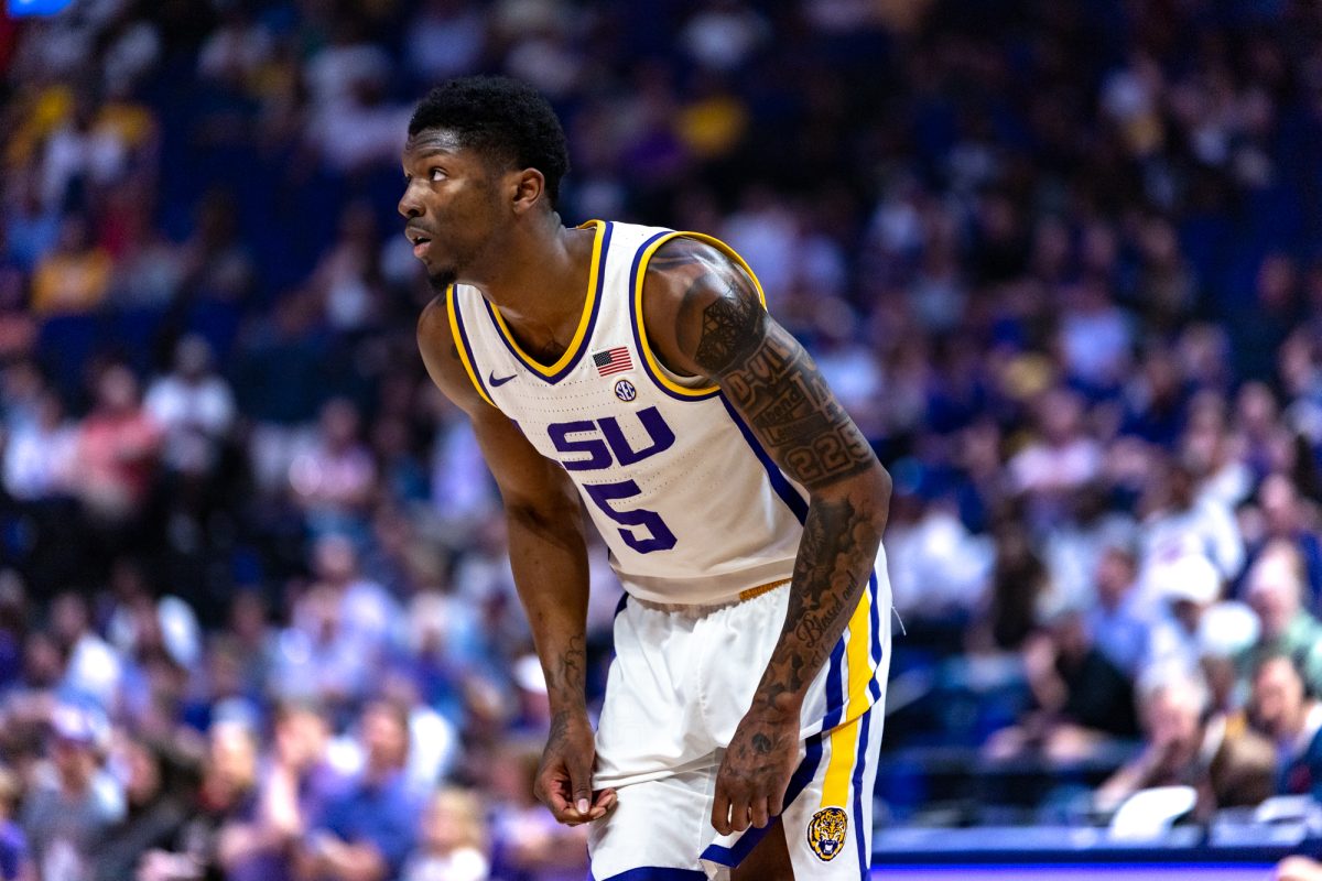 LSU men’s basketball senior guard Cam Carter (5) listens to LSU men’s basketball head coach Matt McMahon during LSU's 70-72 loss against Ole Miss on Saturday, Feb. 9, 2025, in the Pete Maravich Assembly Center in Baton Rouge, La.