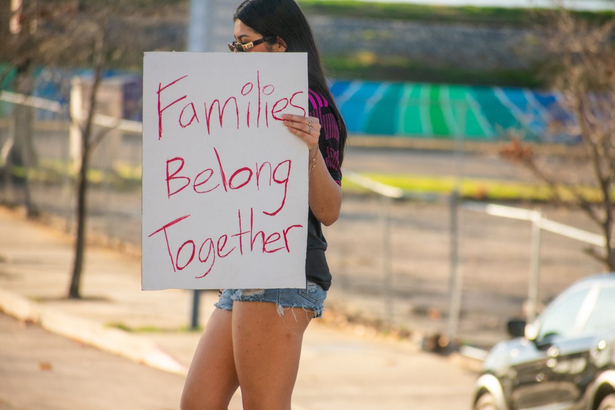 A protester lifts a sign against to mass deportation Sunday, Feb. 2, 2025, at Convention Street and River Road in downtown Baton Rouge, La.