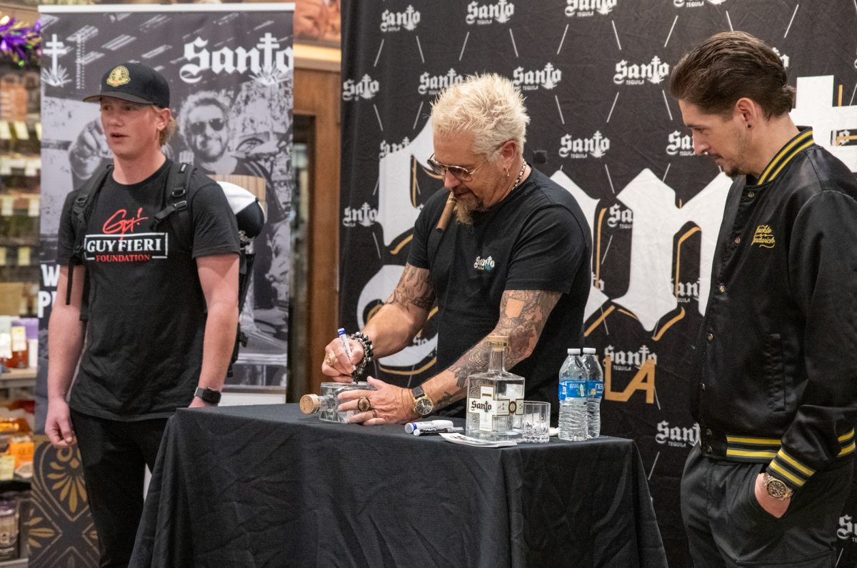 Guy Fieri signs a Santo Tequilla bottle during his bottle signing on Thursday, Feb. 6, 2025, at Total Wine and Spirits on Siegen Lane in Baton Rouge, La.