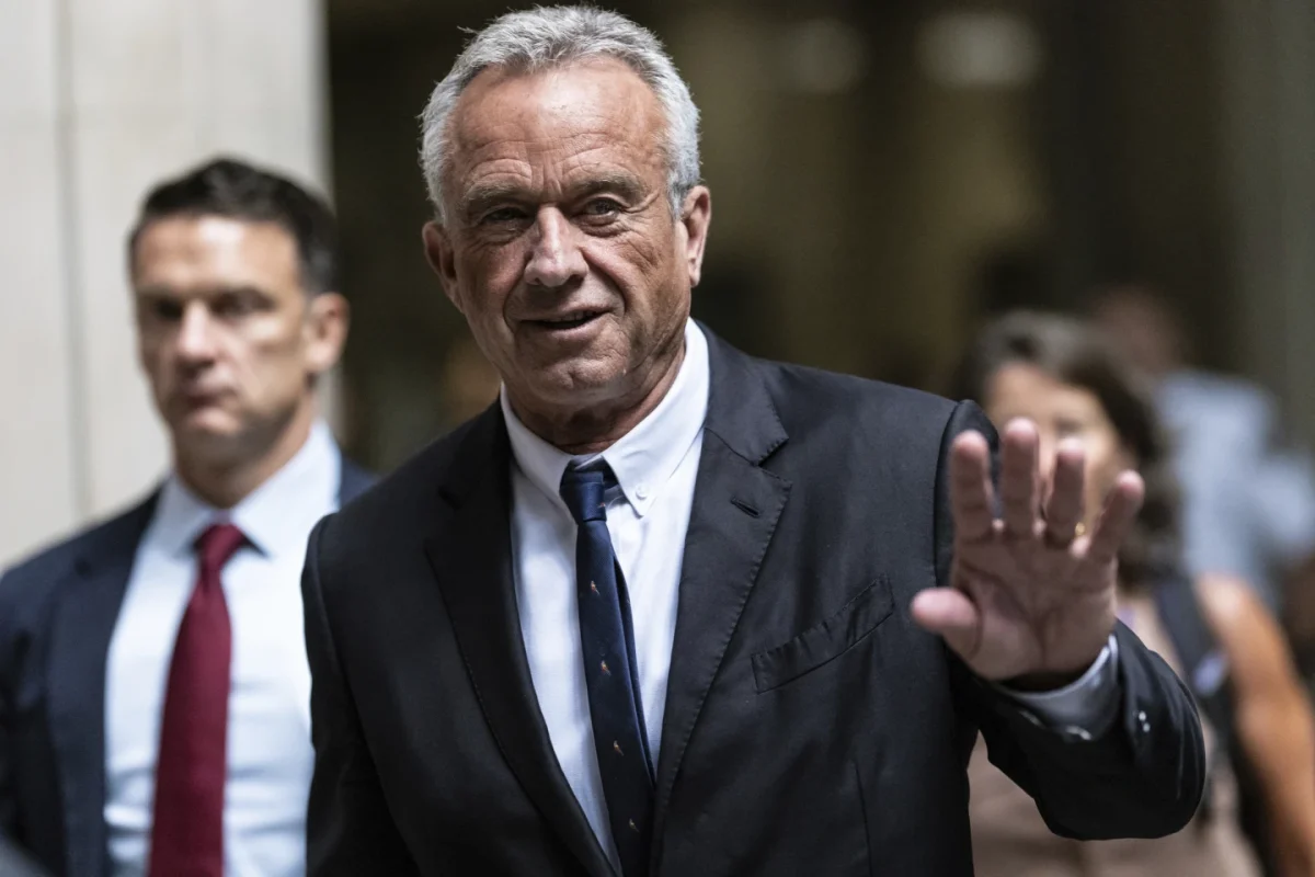 Robert F. Kennedy Jr., waves to the media outside the Nassau County Supreme Court in Mineola, N.Y. on Wednesday, Aug. 21, 2024.