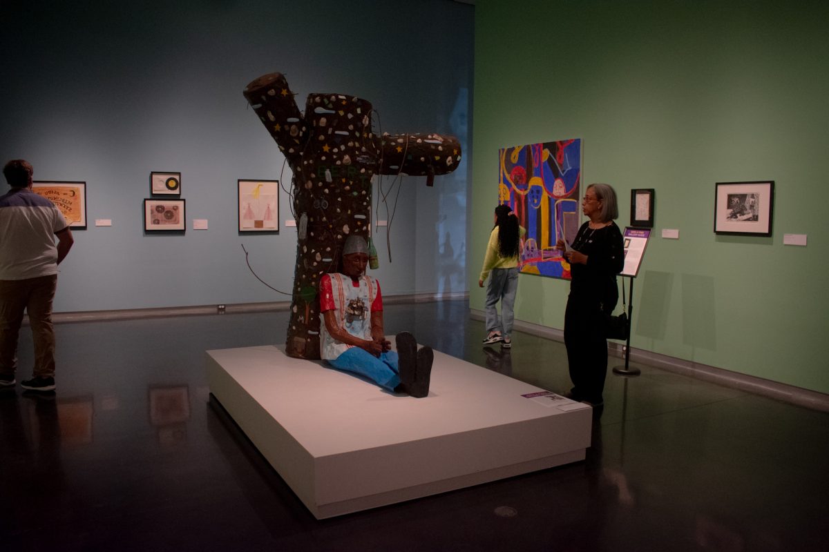 Museum goers view Willie Birch's "Memories of Bertrandville," 1993, mixed media on papier-mâché, Sunday, Feb. 2, 2025, during the Black History Month celebration at the LSU Museum of Art in Baton Rouge, La.