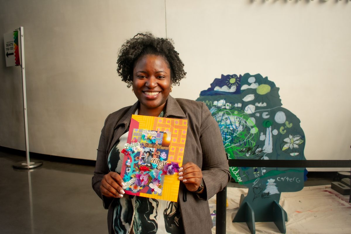 A woman poses with her collage Sunday, Feb. 2, 2025, during the Black History Month celebration at the LSU Museum of Art in Baton Rouge, La.