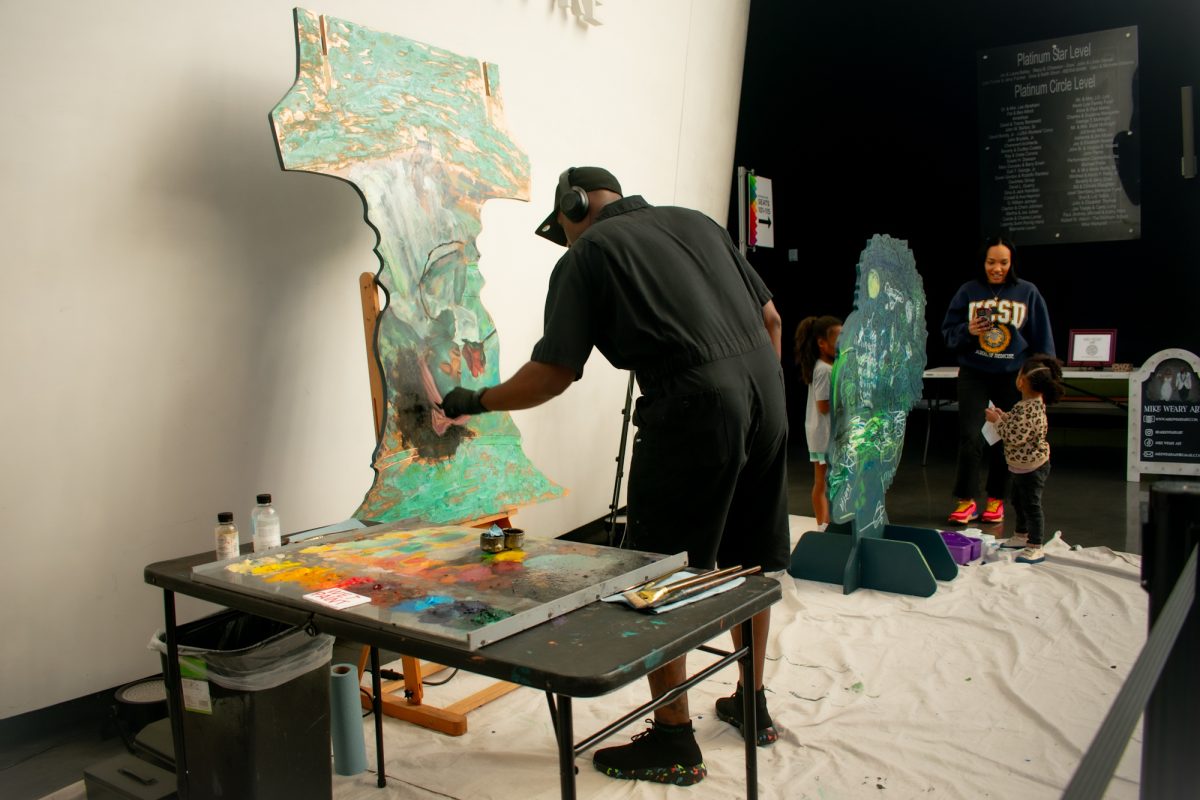 Artist Mike Weary paints during the Black History Month celebration Sunday, Feb. 2, 2025, at the LSU Museum of Art in Baton Rouge, La.