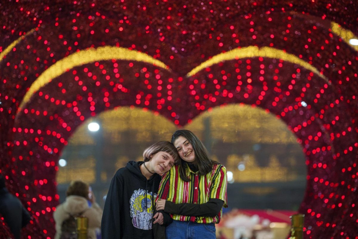 A couple waiting for their turn in a mock marriage ceremony dubbed "Married for one day" in Bucharest, Romania, Tuesday, Feb. 13, 2024.