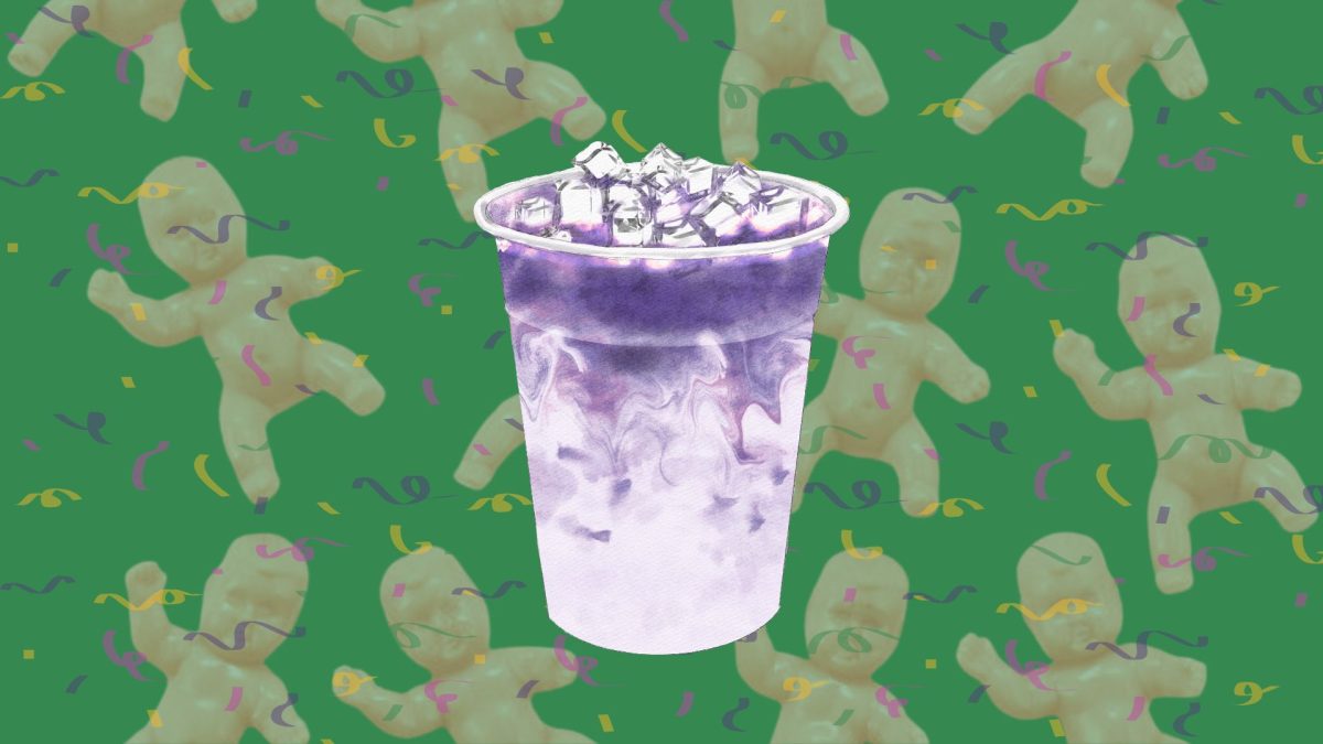 Mardi Gras flavored purple drink in front of king cake babies and confetti.