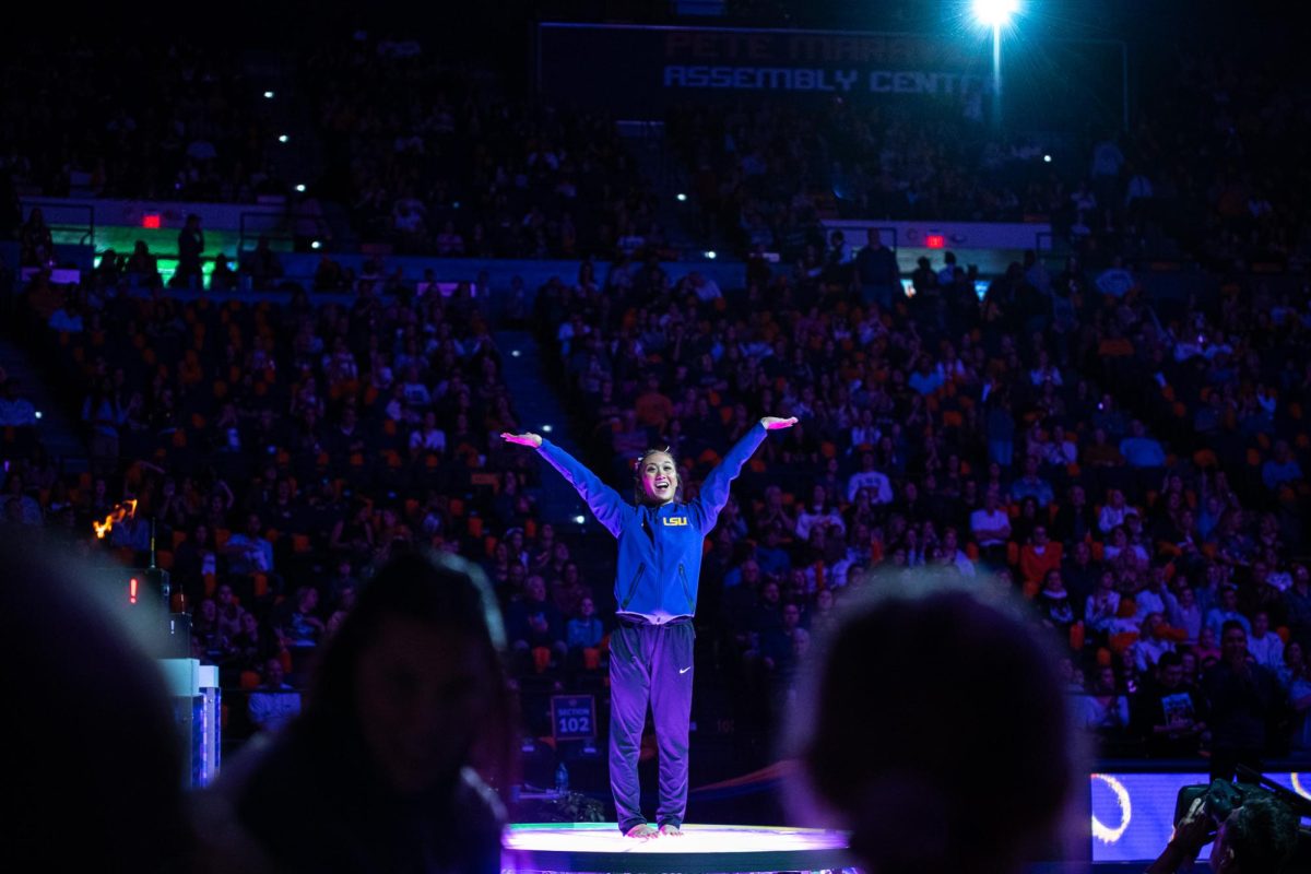 LSU gymnastics all-around freshman Kailin Chio throws her hands up for the crowd before the LSU 198.000-197.175 win against Missouri on Friday, January 31, 2025, at the Pete Maravich Assembly Center in Baton Rouge, LA.