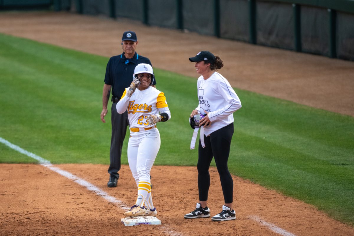 LSU softball sophomore utility Sierra Daniel (23) smiles after making it to first base during LSU's 4-1 win over Kentucky on Friday, March 14, 2025, at Tiger Park in Baton Rouge, La.