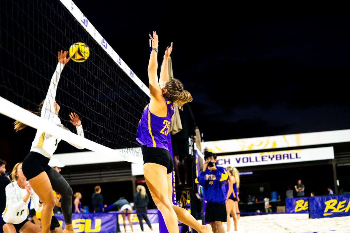 LSU beach volleyball 5th-year senior Emily Meyer (25) attempts to block a spike during the Tiger Challenge on Friday, Feb. 28, 2025, at the LSU Beach Volleyball Stadium on Alaska St.