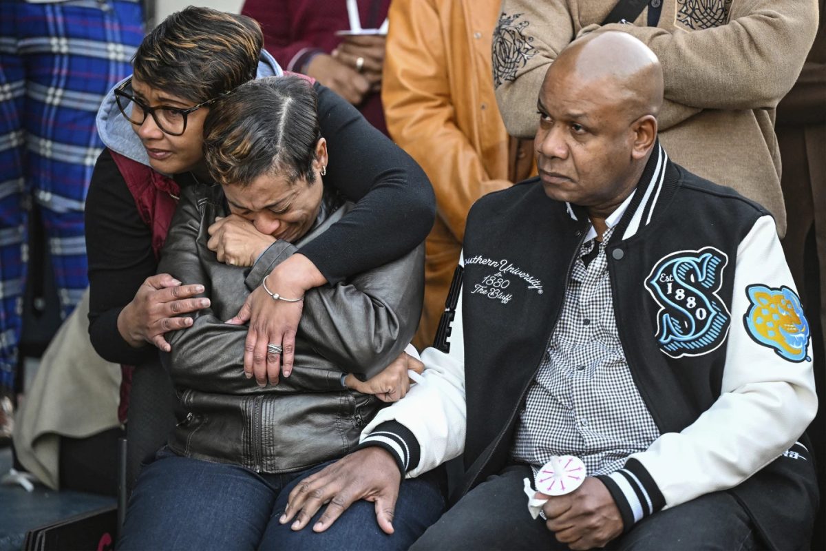 Father Corey Wilson, right, mourns alongside other grieving family members during a vigil for his son, Caleb Wilson on Wednesday, March 5, 2025, in Baton Rouge, La. 