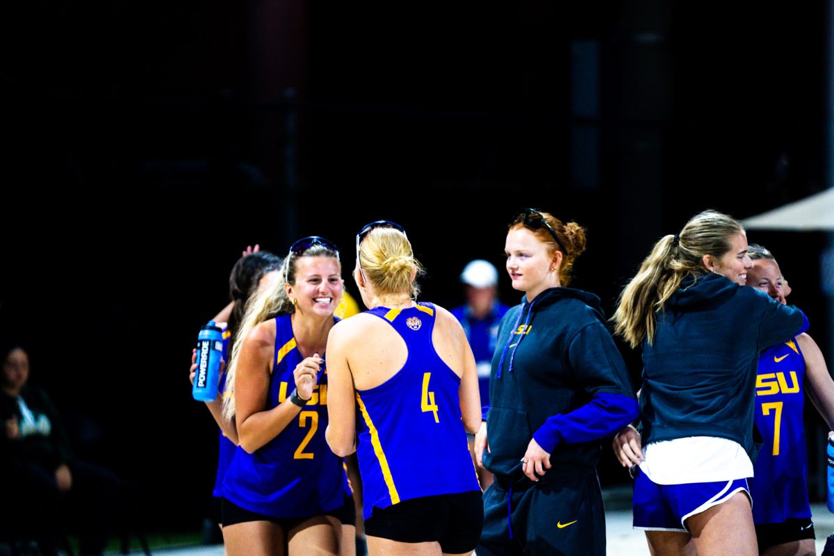 LSU beach volleyball redshirt freshman Kylie Mueller (4) and freshman Elle Evers (2) huddle together before their match during the Tiger Challenge on Friday, Feb. 28, 2025, at the LSU Beach Volleyball Stadium on Alaska St.