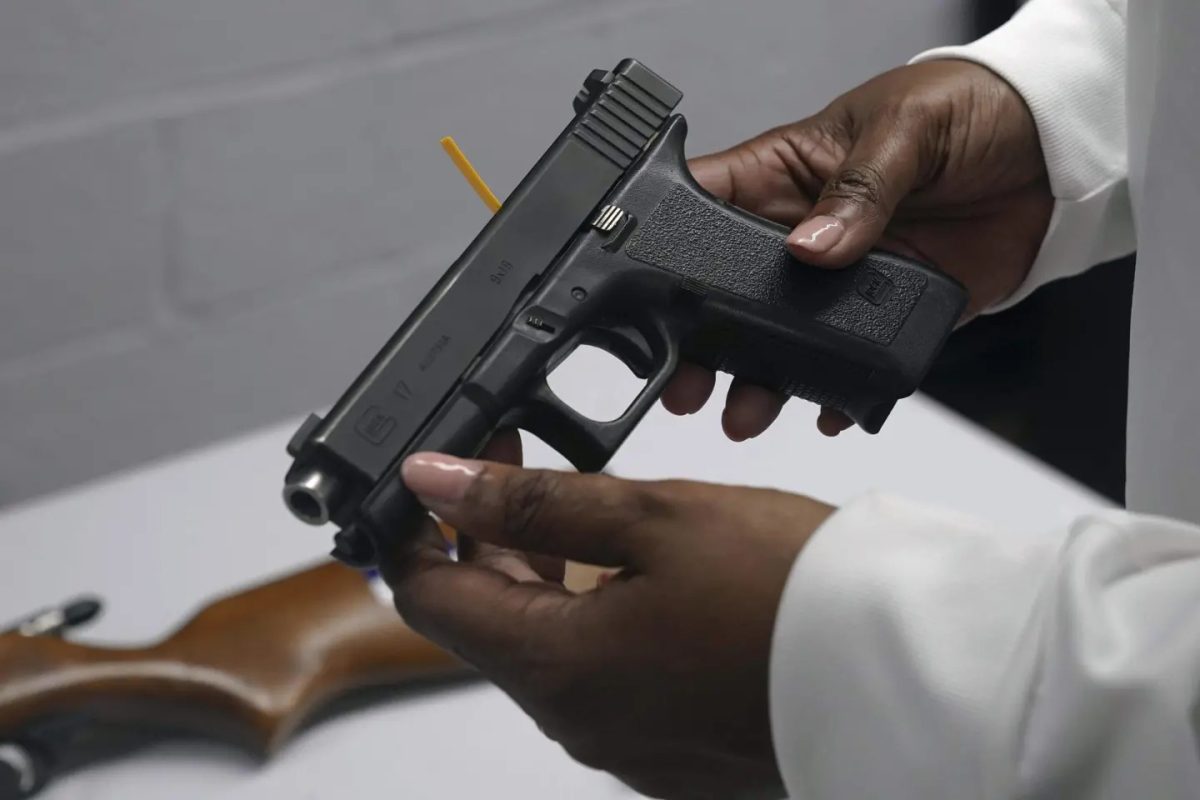 A handgun from a collection of illegal guns is reviewed during a gun buyback event in Brooklyn, N.Y., May 22, 2021.