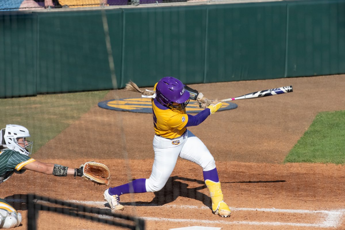 LSU softball junior catcher Maci Bergeron (12) hits the ball during LSU's 3-2 win against Southeastern on Feb 9, 2025, at Tiger Park in Baton Rouge, La.