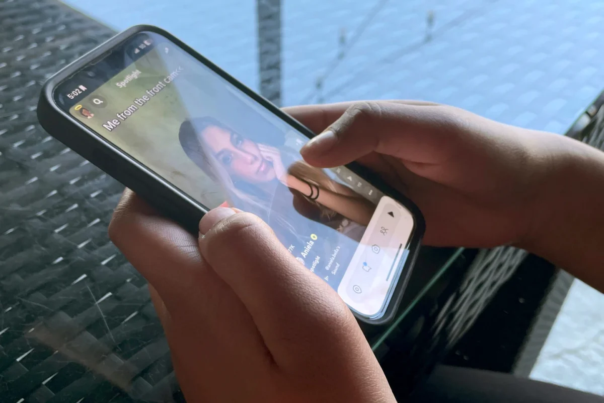 Teenager Shreya Nallamothu looks at her phone in Bloomington, Ill., on Tuesday, May 9, 2023.