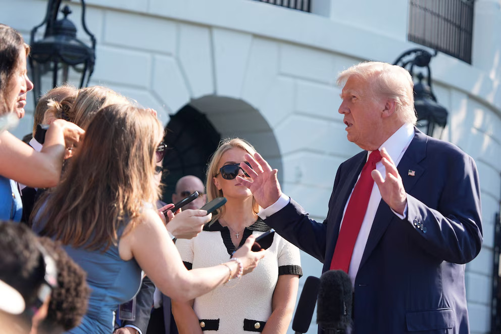 President Donald Trump speaks with reporters before departing on Marine One from the South Lawn of the White House, Friday, July 25, 2025, in Washington.