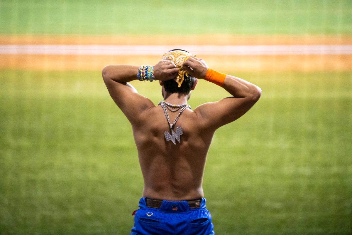 A Texas Tailgater adjusts his bandana while wearing a Whataburger chain Friday, Aug 8, 2025, at Alex Box Stadium in Baton Rouge, La.