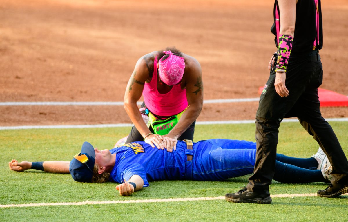 A Party Animal “revives” a Texas Tailgater that is laying on the field Friday, Aug 8, 2025, at Alex Box Stadium in Baton Rouge, La.