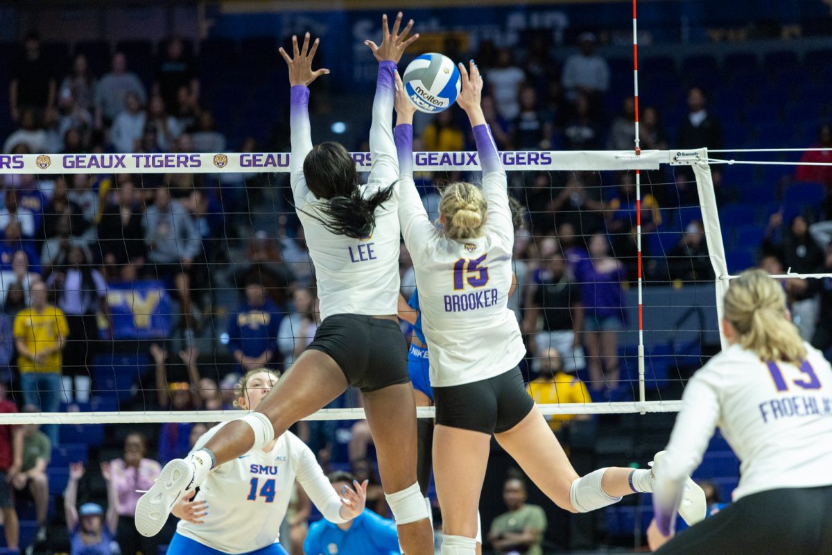 LSU volleyball junior middle blocker Angelina Lee (4) and junior setter Lauren Brooker (15) block the ball Friday, Aug 29, 2025, during their 2-3 loss to SMU at the Pete Maravich Assembly Center in Baton Rouge, La.