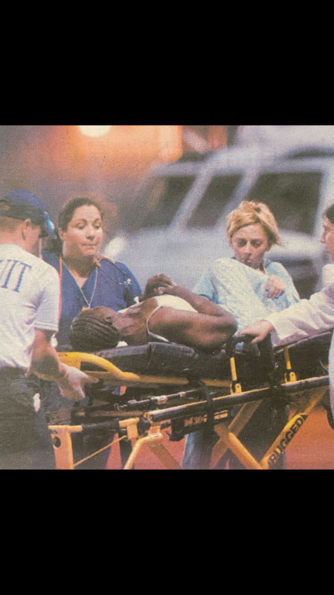 Volunteer medics transfer a New Orleans evacuee from a naval helicopter into the triage center at the PMAC late Tuesday, Aug. 30, 2005.