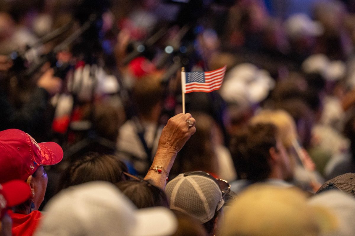A attendee waves their flag during the Turning Point USA rally Monday, Oct. 27, 2025, at the Raising Canes River Center Theatre in Baton Rouge, La.