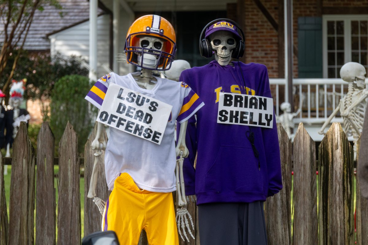 LSU football head coach Brian Kelly and LSU offense skeletons sit Tuesday, Oct. 21, 2025, in Baton Rouge, La.