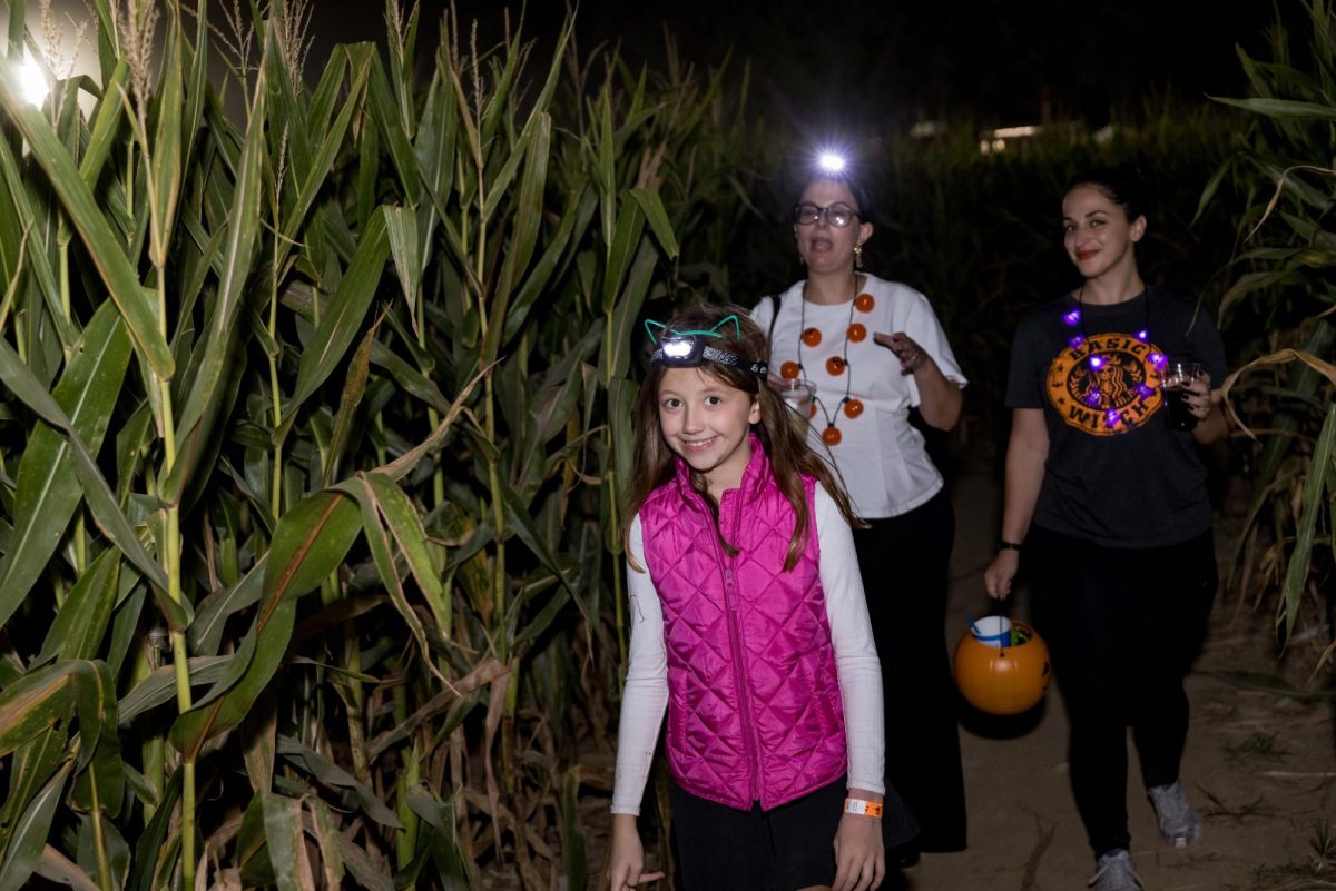 A family makes their way through the Night Maze's corn maze in 2024. (Courtesy of Malorey Uzee)