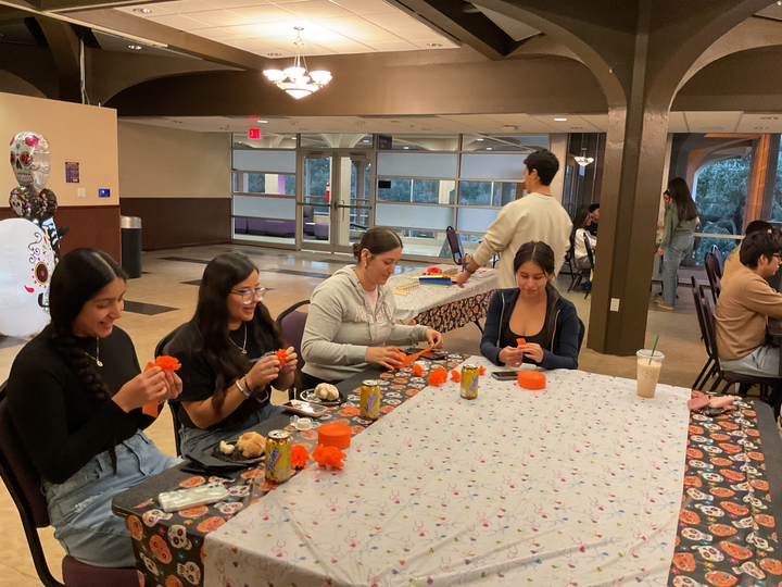 LASO members make paper marigolds to put on the altar at the Dia de los Muertos celebration Thursday October 30 in the Magnolia room of the Student Union.