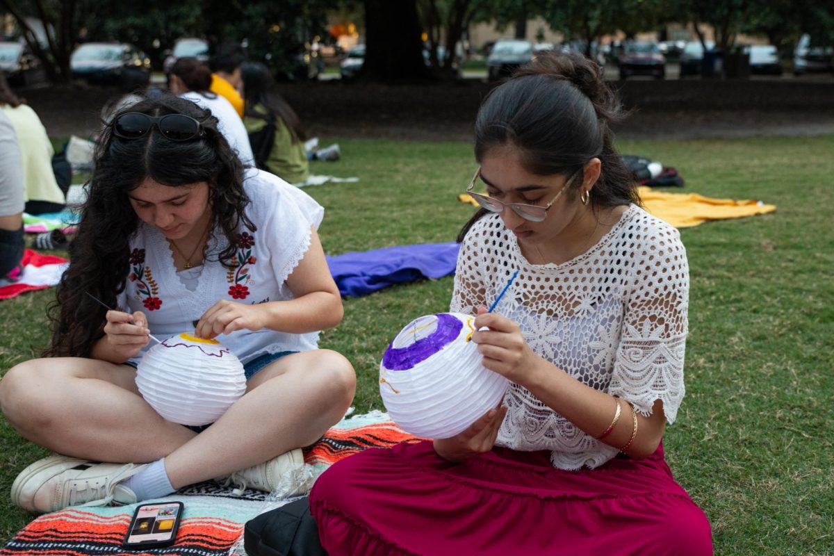 Members of LSU Asian Student Union and Namaste LSU paint lanterns to celebrate Diwali on Tuesday, Oct. 21, 2025, on the Parade Ground on LSU’s campus in Baton Rouge, La.