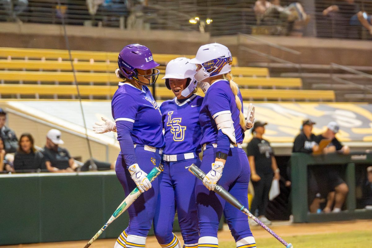 LSU softball players celebrate at the plate during their win over Co-Lin Community College Wednesday, Nov. 12, 2025, at Tiger Park in Baton Rouge, La.