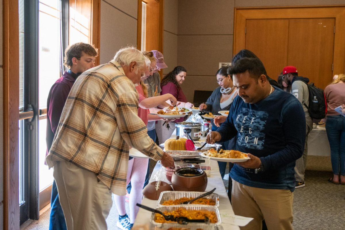Members of the LSU College of the Coast & Environment get food at the International Thanksgiving Potluck event on Wednesday, Nov. 19, 2025, on LSU’s campus in Baton Rouge, La.