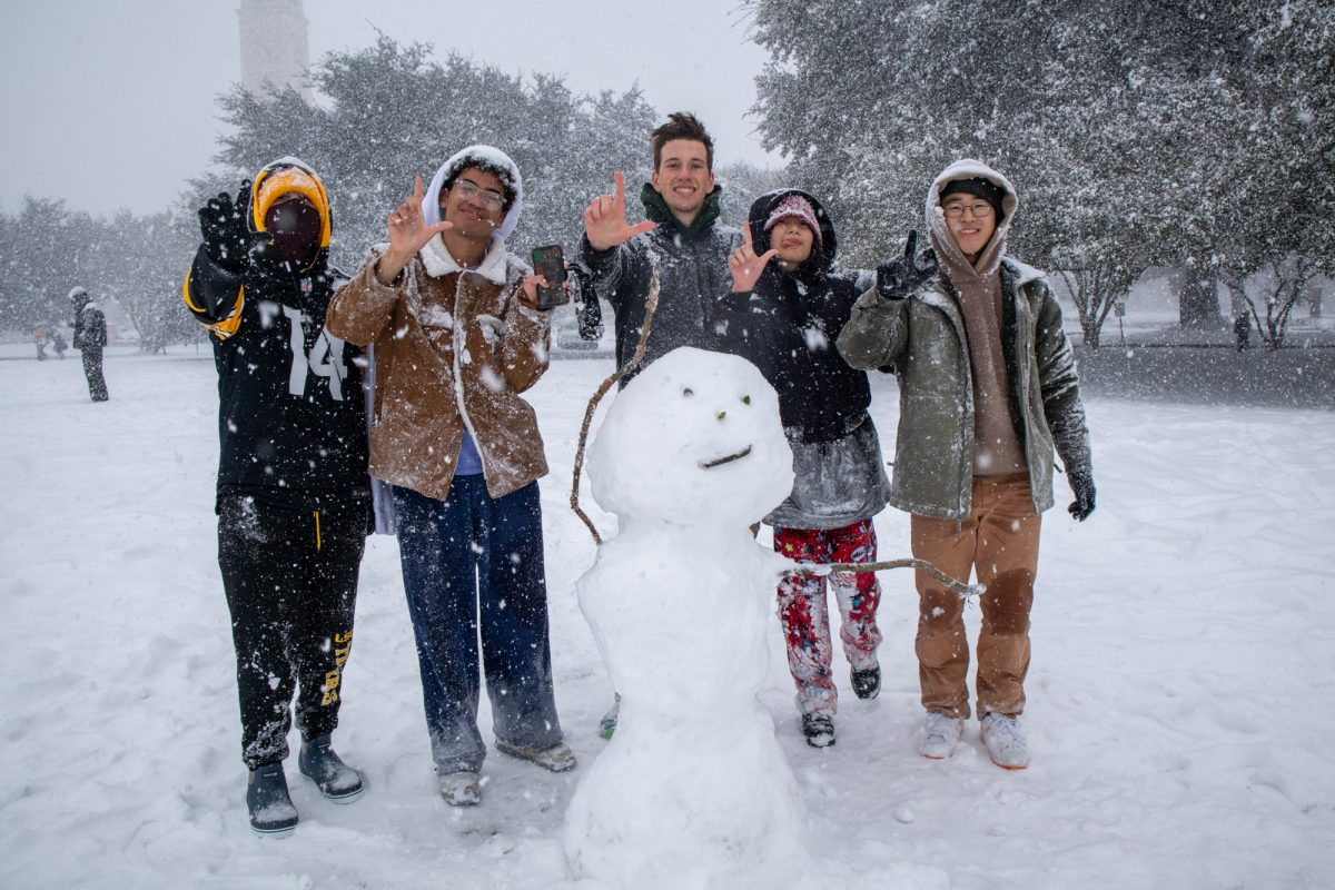 LSU students pose with their snowman Tuesday, Jan. 21, 2025 on the Parade Grounds in Baton Rouge, La.