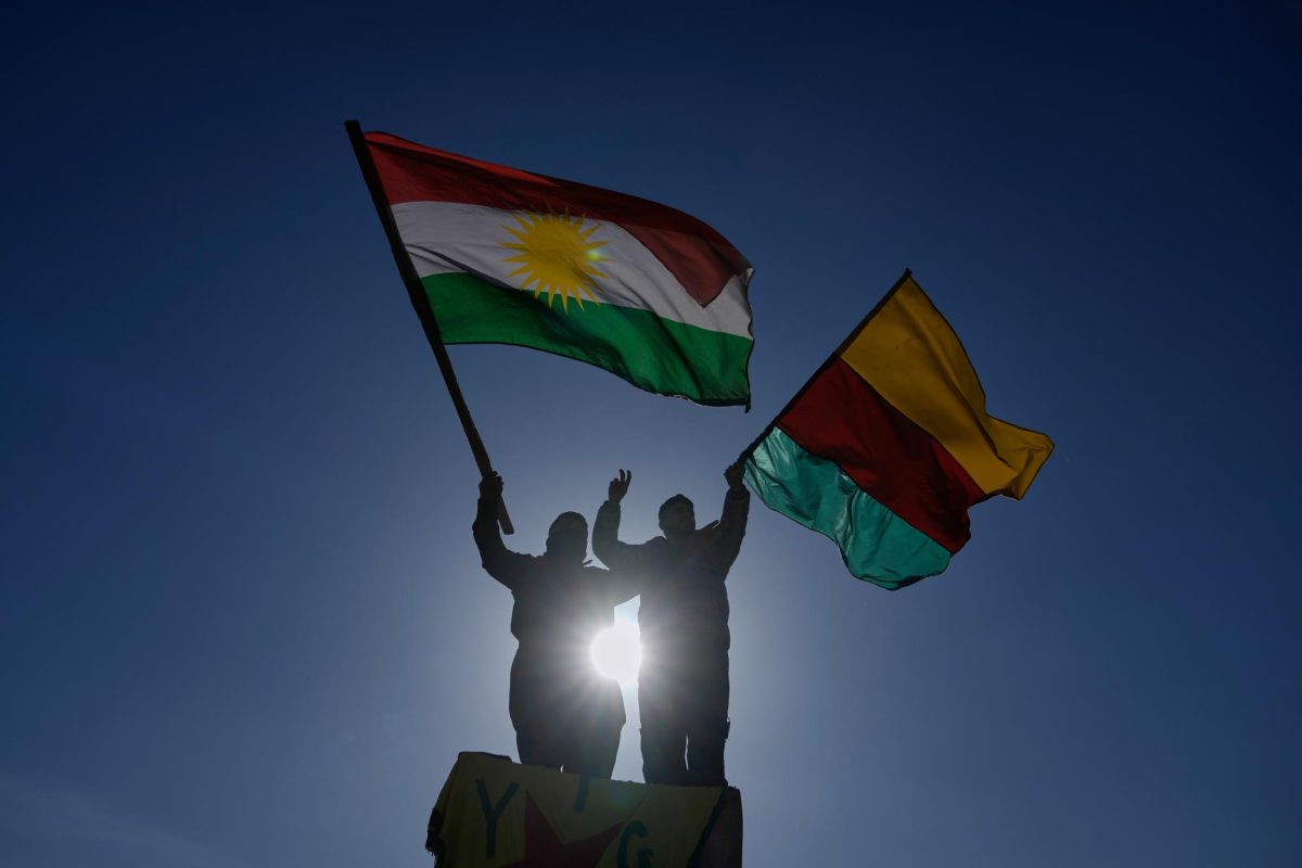 Protesters from the Kurdish community wave party flags during a protest to condemn Syrian government military operations against the Syrian Democratic Forces (SDF) in Syria, outside the ESCWA headquarters in Beirut, Lebanon, Tuesday, Jan. 20, 2026.