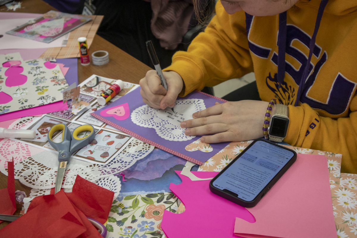 A student writes a Valentine's Day card Wednesday, Feb. 12, 2025, at the LSU Library in Baton Rouge, La.