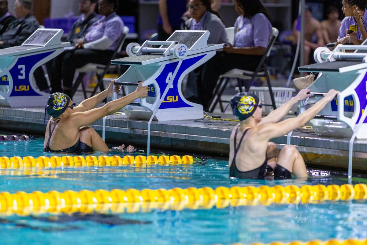 LSU swimming and diving sophomore backstroke/butterfly/individual medley Zoe Carlos-Broc (left, lane 4) and sophomore backstroke/individual medley Lauren Bernardo (right, lane 5) prepare to swim the women's 100 backstroke Saturday, Jan. 24, 2026, at the LSU Natatorium in Baton Rouge, La.