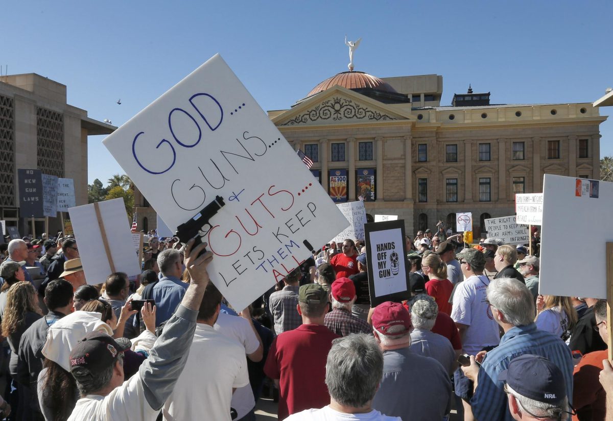 Gun rights supporters stand outside the Capitol in Phoenix on Saturday, Jan. 19, 2013, during a Guns Across America rally. The nationwide rally was in support of the Second Amendment and called for no new gun laws. 