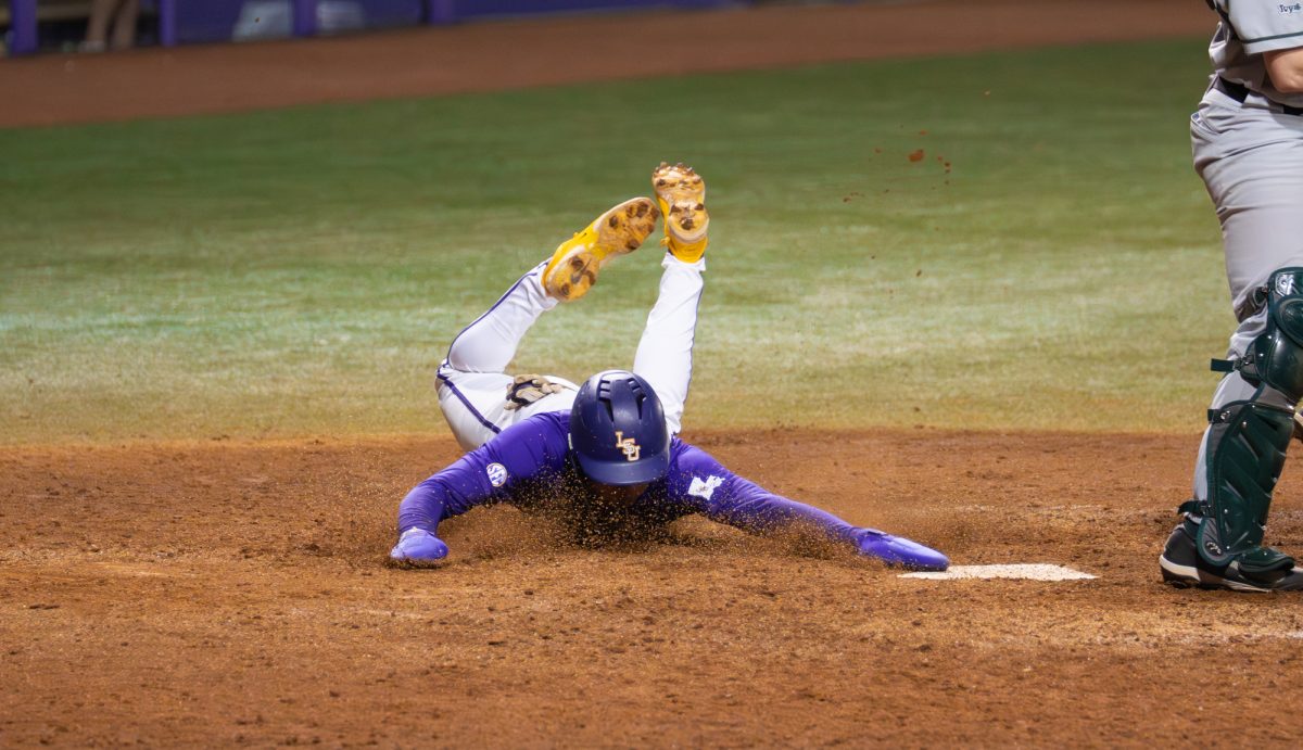 LSU baseball sophomore outfielder Derek Curiel (6) slides into home during the Tigers' 5-3 win over Dartmouth Friday, Feb. 28, 2026 at Alex Box Stadium in Baton Rouge, La.