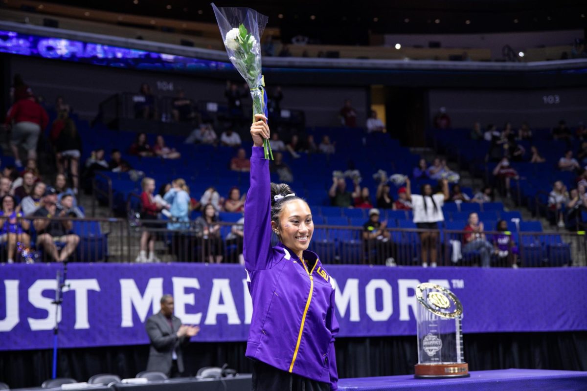 LSU gymnastics all-around sophomore Kailin Chio raises a bouquet of flowers during the SEC Championship Saturday, March 21, 2026, at the Bank of Oklahoma Center in Tulsa, Okla.