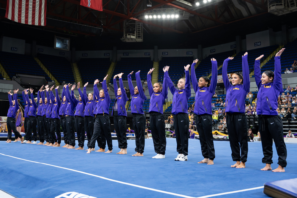 LSU gymnastics players wave during the Podium Challenge against Alabama, North Carolina and Arizona Sunday, March 1, 2026, at the Raising Cane’s River Center in Baton Rouge, La.