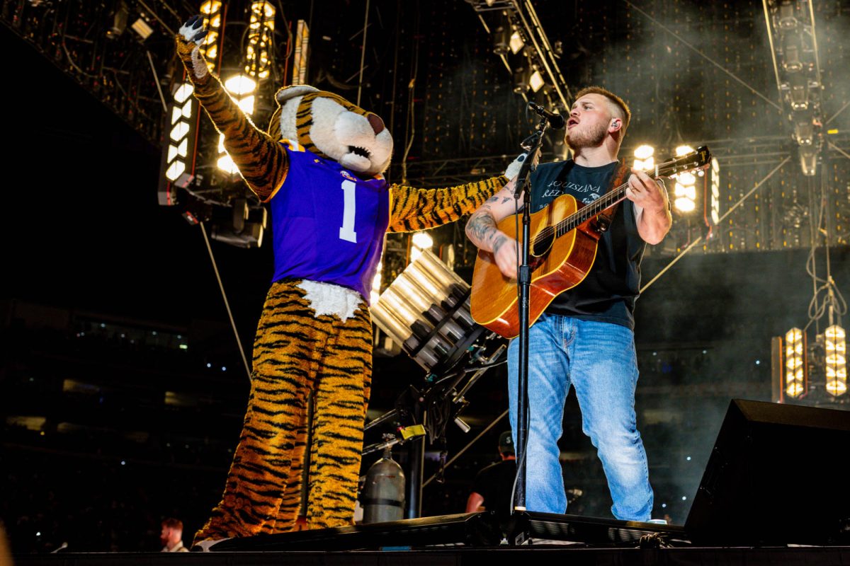 Zach Bryan sings with Mike the Tiger Saturday, March 28, 2026 at Tiger Stadium in Baton Rouge, La.
